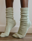 girl on tippy toes wearing green socks