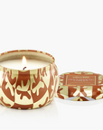 Candle in a decorative container with a pattern on a white background