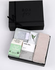 BOXFOX Black Gift Box filled with Royal Treatmint Big Heart Tea, Pure Sol Charcoal Eye Pads, BOXFOX tan cozy socks, set of Herban Essentials Eucalyptus wipes and Touchland hand sanitizer