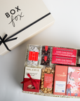 Gift box with various confectioneries and a branded box labeled 'Box Fox' on a light background.