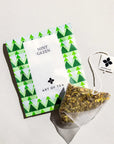 Tea package with green triangle design and 'Art of Tea' branding on a light gray background