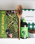 PASTA ET AL gift box which includes: Pasta Et Al cookbook, Wooden Pasta Spoon, Graza "Drizzle" Olive Oil, Geometry Green Checkered Tea Towel, and Marble Salt Cellar with wooden top