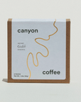 A box of Canyon Coffee instant coffee with a minimalist design, featuring a beige and white color scheme and the brand's logo.