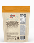 Back of a Texas Treats snack mix package with text and nutrition facts.