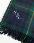 Plaid scarf with monogram 'KMK' on a white background