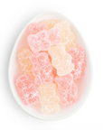 Gummy bears in a white bowl on a white background
