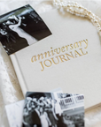 Anniversary journal with black and white photos on a soft white background