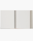 White notebook with a spiral binding on a white background