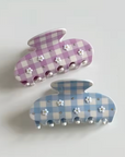 Two checkered bunny-shaped hair clips on a light gray background