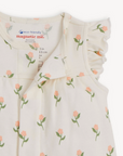 Baby dress with floral pattern and 'magnetic me' branding on a white background
