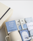 Gift set with tea, socks, and other items on a white surface