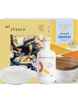 Gift set with a bottle of Brightland olive oil, a bowl, and a book titled 'al fresco' on a white background.