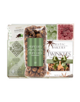 A gift set from Rustic Bakery featuring caramel corn, peppermint popcorn, caramels, and Twinkies, packaged in a white box with green accents and a clear window showing the treats inside.