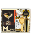 A curated gift box set from The Martin Bar featuring a gold cocktail shaker, a bottle of Martin's Olives Almonds, a gold strainer, and a branded cocktail card, all arranged in white paper shred inside a gift box.