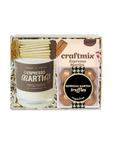 Craftmix Espresso Martini gift set in a white box with shredded paper filler, containing a white candle with a brown label and a clear package of espresso martini truffles.
