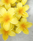 Yellow artificial flowers on a marble surface