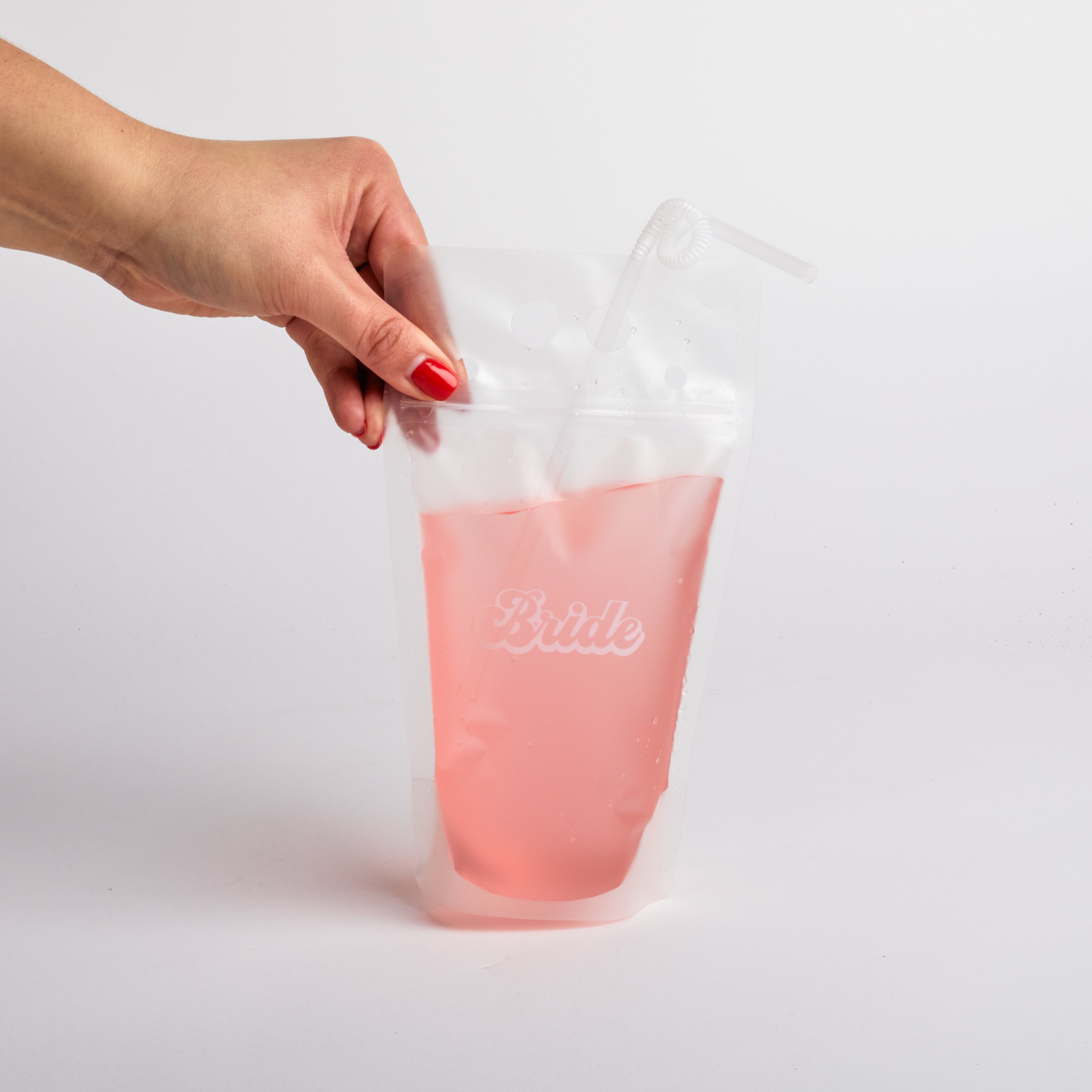 Hand holding "bride" drink pouch.