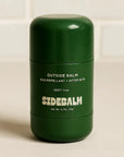 Green container of SideBalm Outside Balm on a beige background
