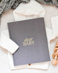 grey textured journal with gold lettering that says "dear baby"