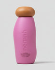Pink bottle with brown cap on a light gray background