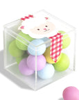 Pastel-colored play balls with a cartoon sheep character in a clear cube on a white background