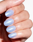 Hand with light blue nail polish on a white background