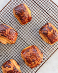 Croissants on a cooling rack with a white background