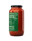 Jar of red sauce with a green label on a white background