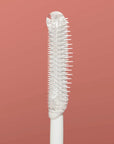 White bristle brush on a red-brown background