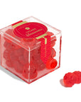 Red gummy bears in a clear cube container with 'L'chay blossoms' branding on a white background.