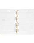 White notebook with gold spiral binding on a white background