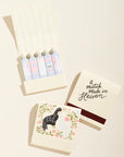 Set of matches with decorative packaging featuring a bird illustration and text on a beige background
