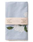 blue tea towel with white hydrangea embroidered on it