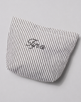 A small fabric pouch with thin black and white vertical stripes and the name 'Fyra' embroidered in black script on the front, photographed on a light gray background.