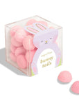 clear candy cube filled with round, pink candies