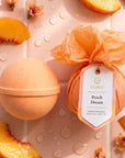 Peach-themed bath bomb with packaging on a background of peach slices and flowers.