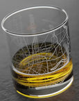Glass with a map engraving and yellow base on a dark background