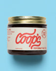 Jar of Coop's product on a white background