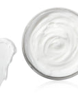 Glass bowl filled with white cream on a white background
