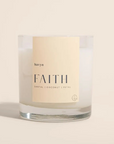Candle with 'FAITH' branding on a beige background