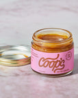 Jar of Coop's salted caramel on a marble surface