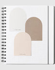 Notebook with geometric arch designs on a white background