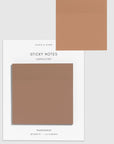 A pack of transparent sticky notes in the color 'Cappuccino' on a white backing card, with one note shown floating above the card against a light gray background.