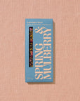 A rectangular chocolate bar packaged in sky blue paper with beige text reading "Lavender Rose"