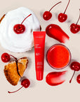 red lip balm surrounded by cherries & cherry pie