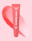 Pink lip balm tube with 'esw beauty' branding on a pink background