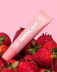 Pink lip balm with 'SWEET BERRY' text on a pink background with strawberries