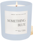 Candle in a light blue jar with a label on a white background