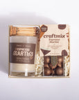 A gift set in a light wood box containing a candle labeled 'Espresso Martini' and a package of craftmix Espresso Martini chocolate truffles, arranged on a white background.