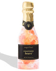 Sugarfina Champagne Bears candy in a clear glass bottle with a gold foil neck wrap and a black label, shown on a white background with a soft shadow.
